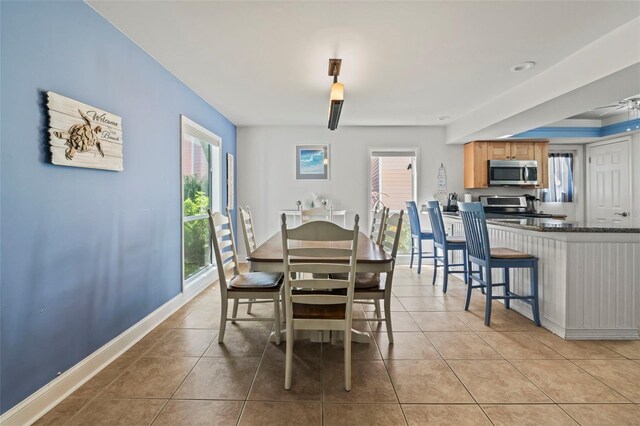 tiled dining room featuring ceiling fan