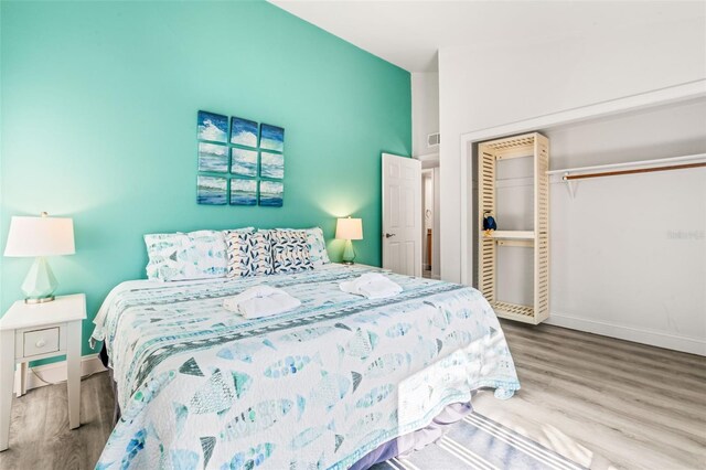 bedroom featuring wood-type flooring and a closet