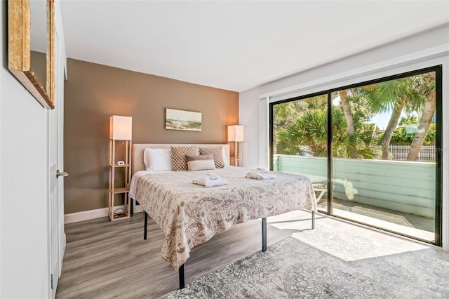 bedroom with hardwood / wood-style flooring and access to exterior