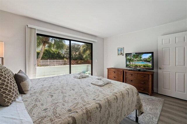 bedroom featuring access to outside and hardwood / wood-style floors