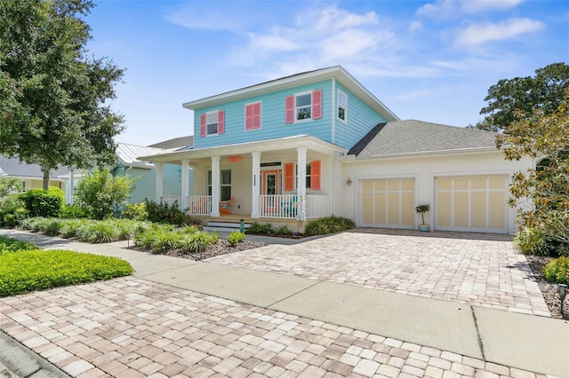 view of front of property featuring a garage and a porch