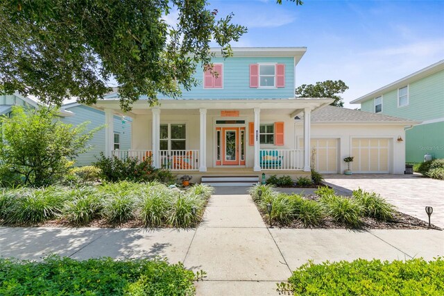 view of front facade with a garage and covered porch