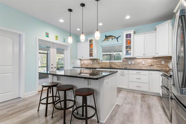 kitchen with a center island, sink, light hardwood / wood-style flooring, and white cabinetry