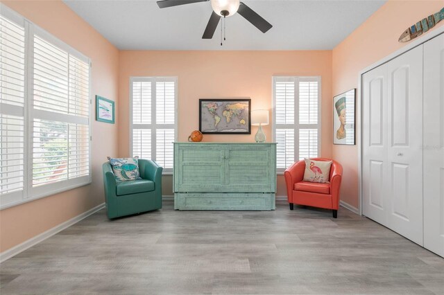 living area featuring ceiling fan and light wood-type flooring