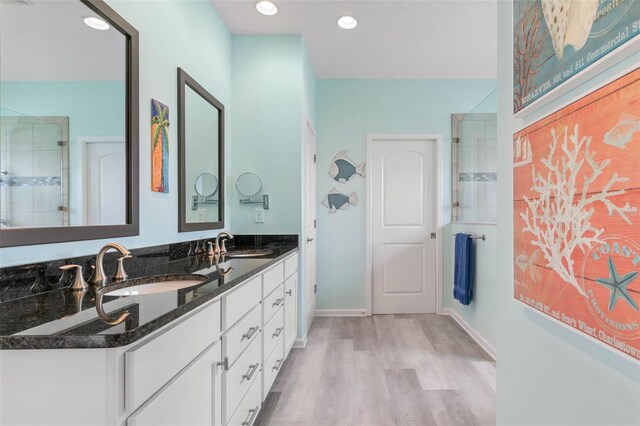 bathroom with vanity, hardwood / wood-style floors, and an enclosed shower