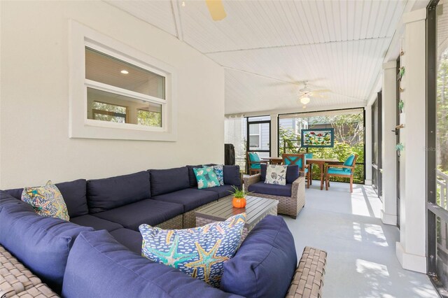 living room with a healthy amount of sunlight, concrete floors, and ceiling fan