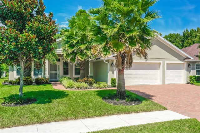 view of front of home featuring a garage and a front lawn