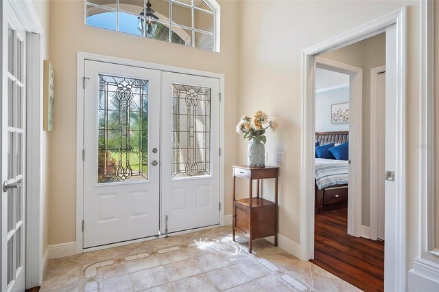 entrance foyer featuring light hardwood / wood-style floors and french doors