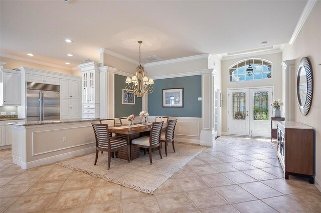 tiled dining room with crown molding and a notable chandelier