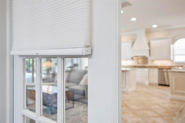 room details featuring custom exhaust hood and stainless steel dishwasher