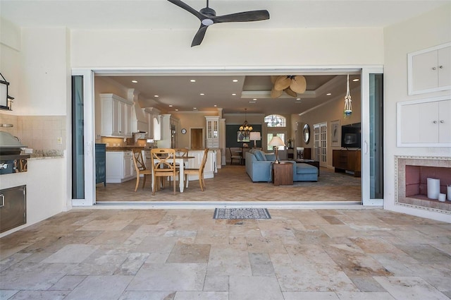 interior space with ceiling fan