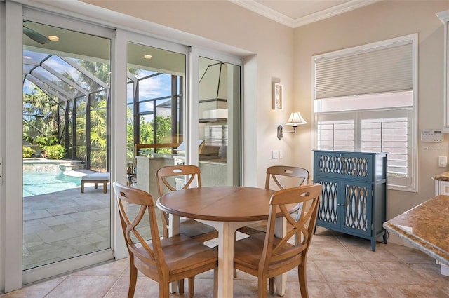 tiled dining area with crown molding and a healthy amount of sunlight