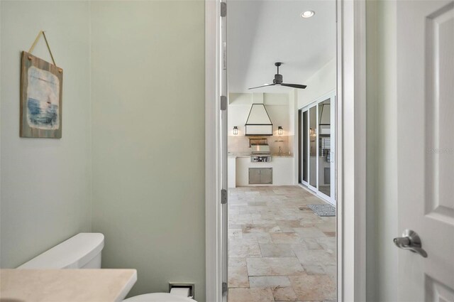 bathroom featuring ceiling fan, toilet, and vanity