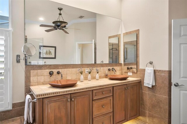 bathroom featuring backsplash, ceiling fan, ornamental molding, and vanity