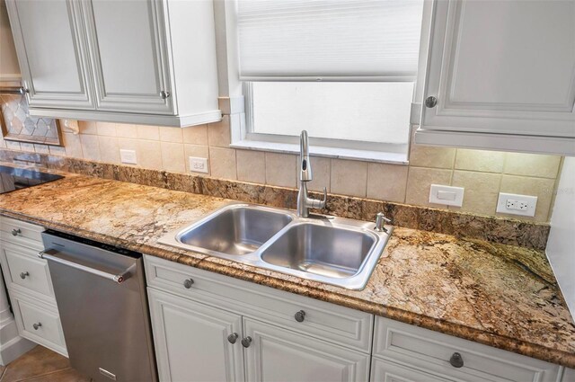 kitchen with white cabinets, dishwasher, and sink