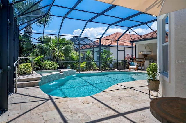 view of swimming pool featuring glass enclosure, an in ground hot tub, pool water feature, and a patio