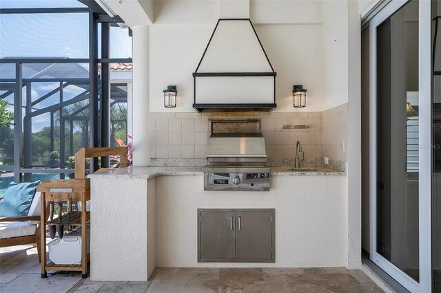 kitchen featuring tasteful backsplash and light stone counters