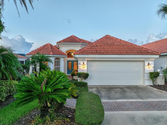 mediterranean / spanish house featuring a garage