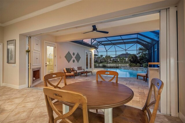 tiled dining space featuring lofted ceiling, ceiling fan, and a wealth of natural light