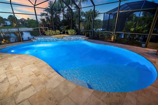 pool at dusk with a water view, an in ground hot tub, and a lanai