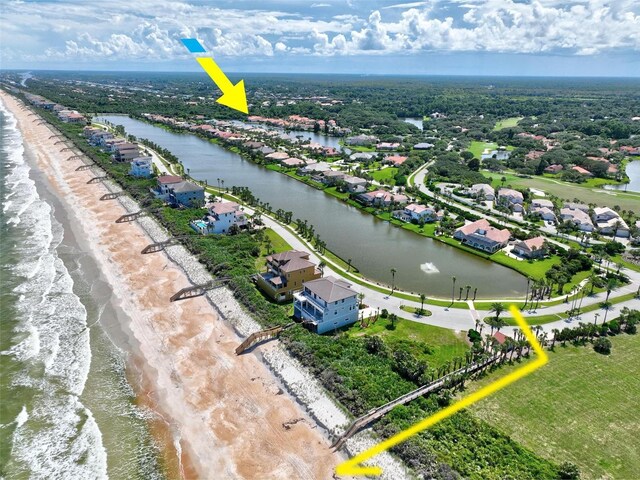 bird's eye view with a view of the beach and a water view