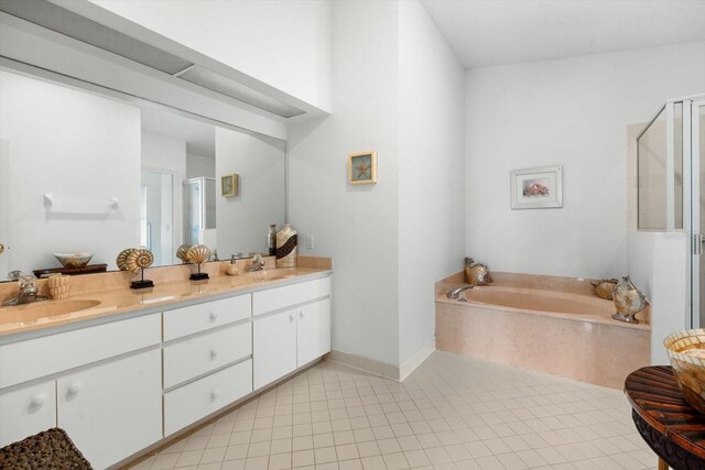 bathroom featuring vanity, independent shower and bath, and tile patterned floors