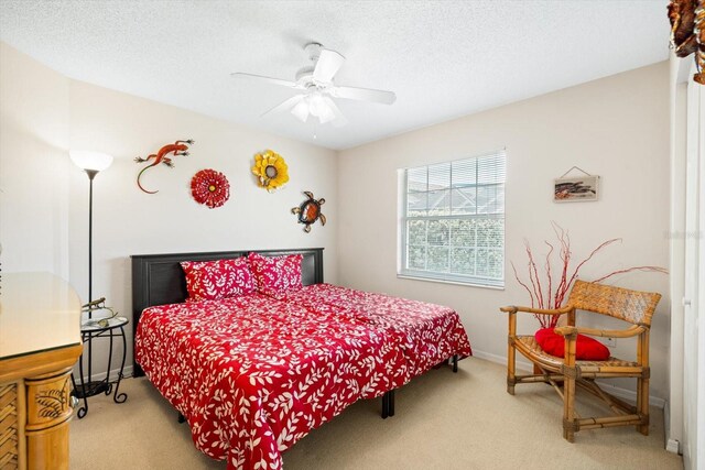 carpeted bedroom with a textured ceiling and ceiling fan