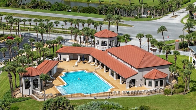 view of swimming pool with a yard and a patio