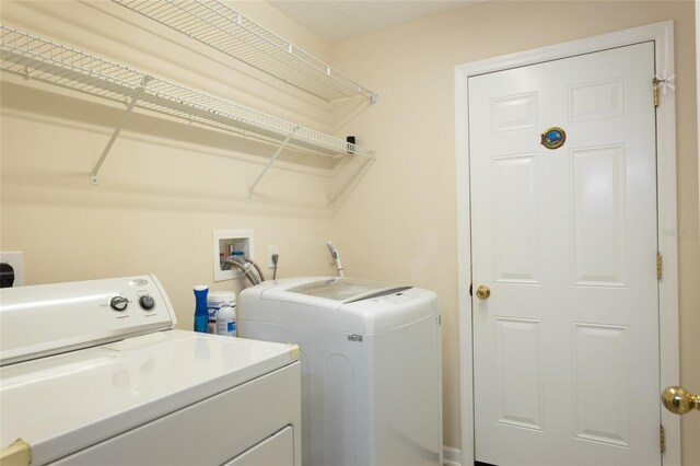 clothes washing area featuring washer and clothes dryer