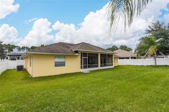 back of house featuring a sunroom, a yard, and cooling unit