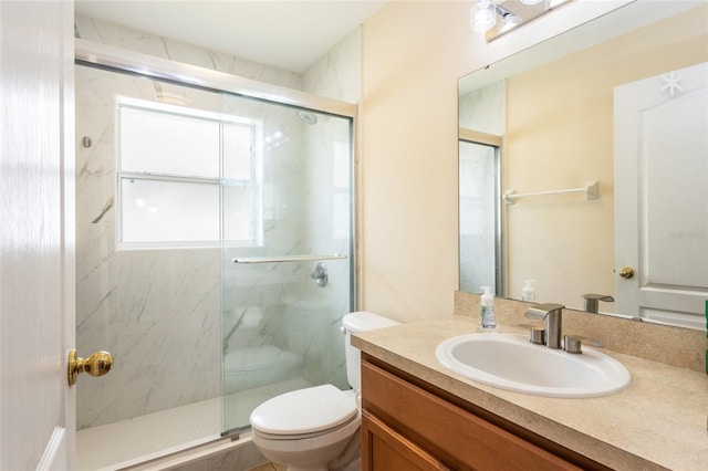 bathroom featuring vanity, toilet, and walk in shower