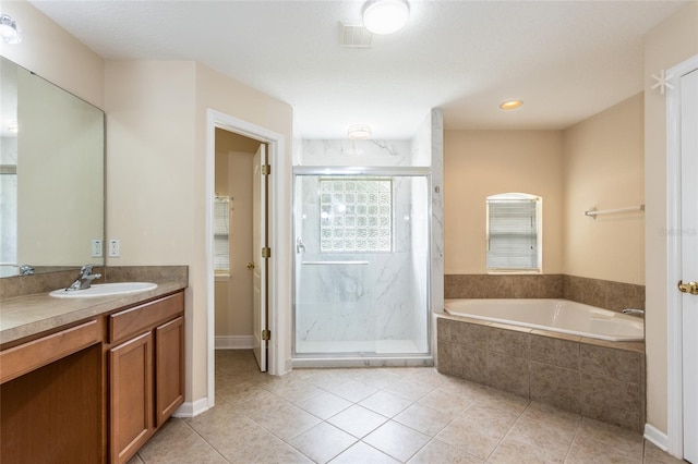 bathroom with tile patterned flooring, vanity, and shower with separate bathtub