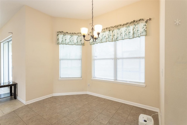 unfurnished dining area featuring a notable chandelier and light tile patterned flooring