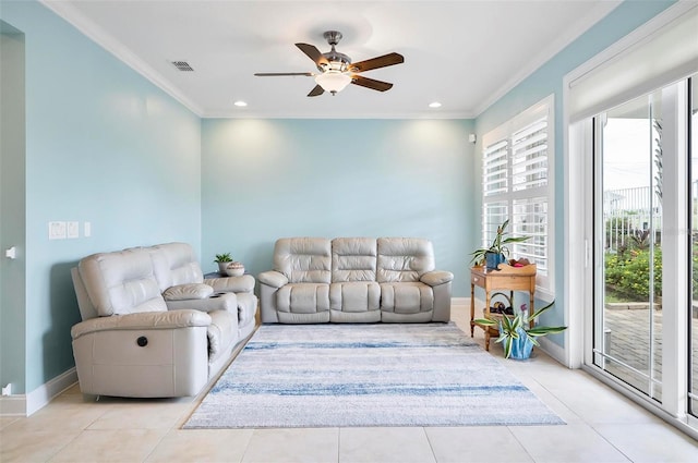 tiled living room with ceiling fan, plenty of natural light, and crown molding