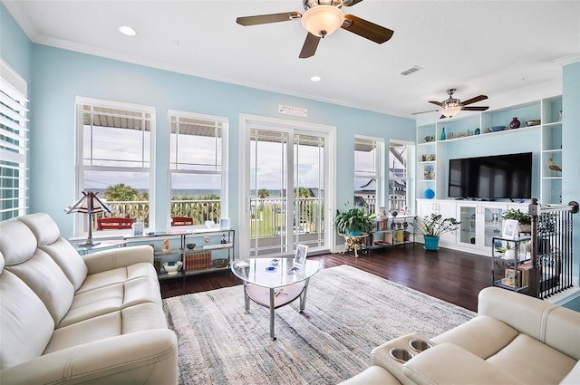 living room with dark wood-type flooring, ceiling fan, and ornamental molding