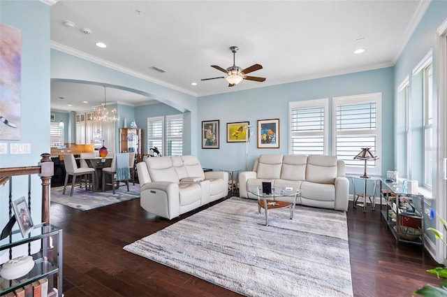 living room featuring ceiling fan with notable chandelier, plenty of natural light, dark hardwood / wood-style floors, and crown molding