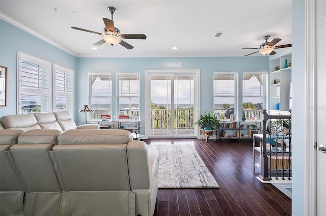 living room featuring crown molding, dark wood-type flooring, and ceiling fan