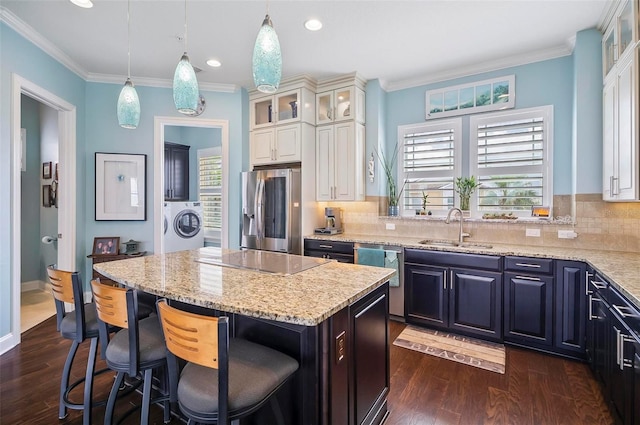 kitchen with dark hardwood / wood-style floors, a center island, stainless steel appliances, sink, and white cabinets