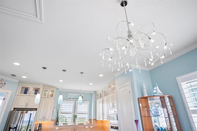 room details with oven, ornamental molding, stainless steel fridge, and sink