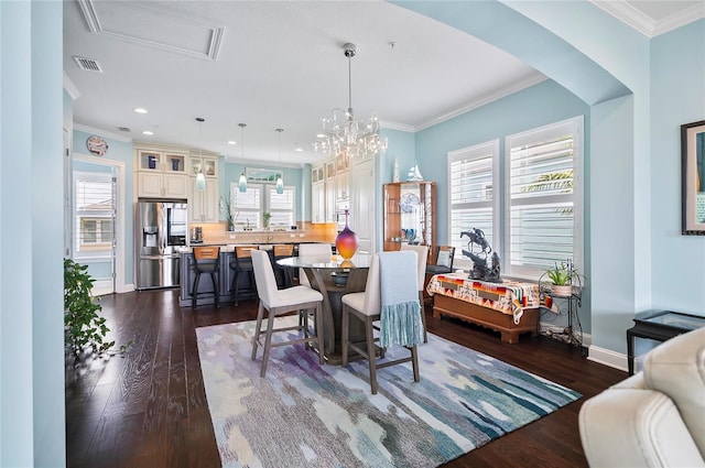 dining room with a wealth of natural light, dark wood-type flooring, and ornamental molding