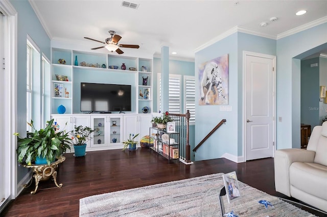 living room with crown molding, ceiling fan, and dark hardwood / wood-style flooring