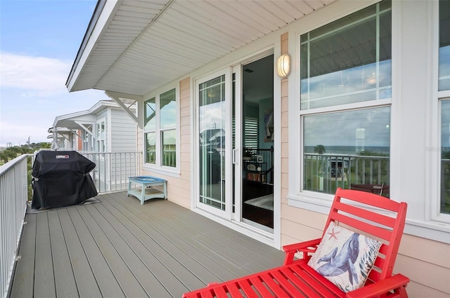 wooden deck featuring a grill