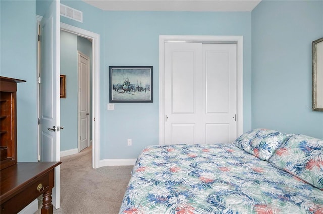 bedroom featuring light carpet and a closet