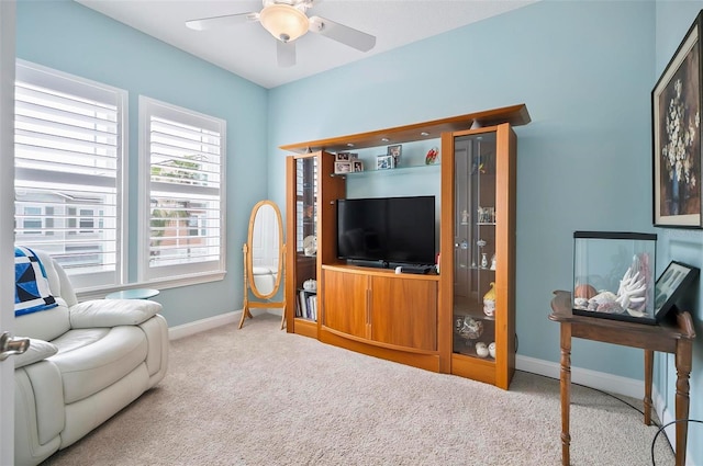 carpeted living room featuring ceiling fan