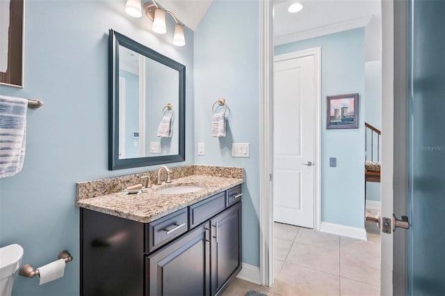 bathroom with tile patterned flooring, toilet, and vanity