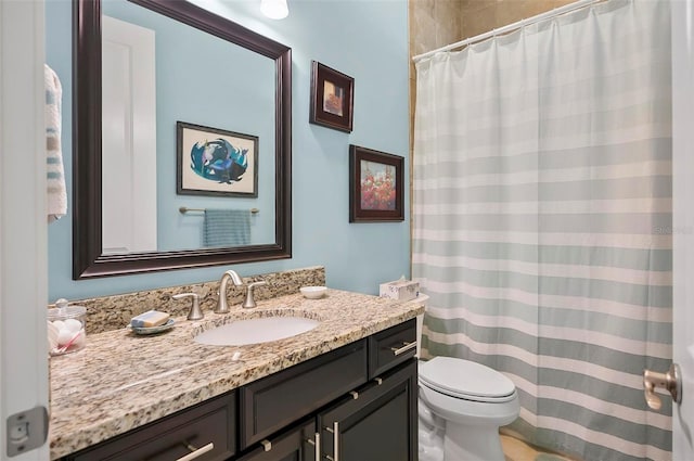 bathroom with vanity, toilet, and curtained shower