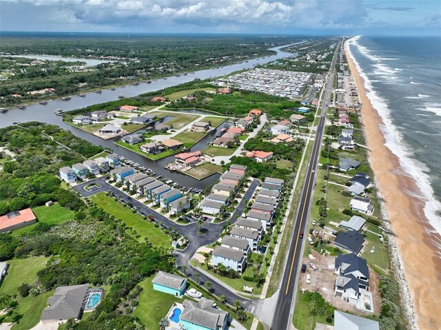 bird's eye view featuring a view of the beach and a water view