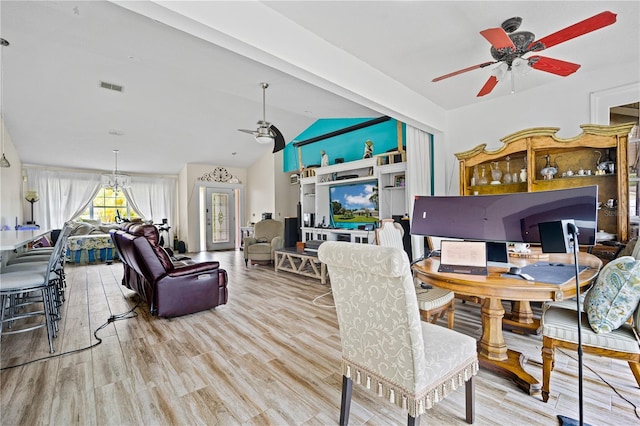 dining room featuring light hardwood / wood-style flooring, ceiling fan, and vaulted ceiling