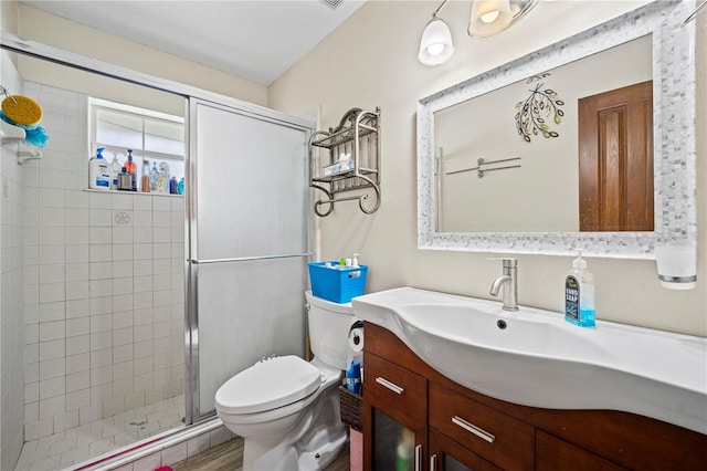 bathroom with vanity, toilet, and walk in shower