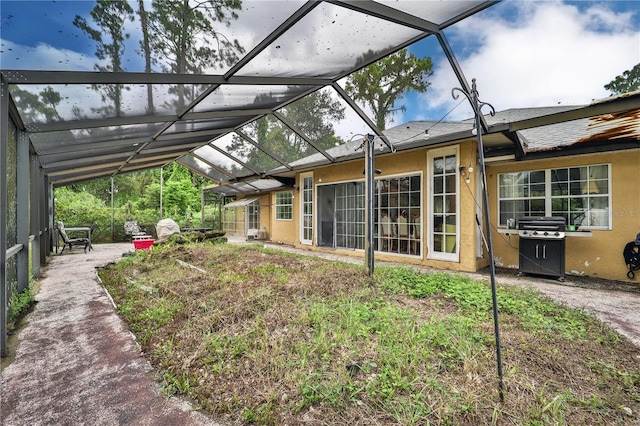 exterior space featuring glass enclosure and a patio area